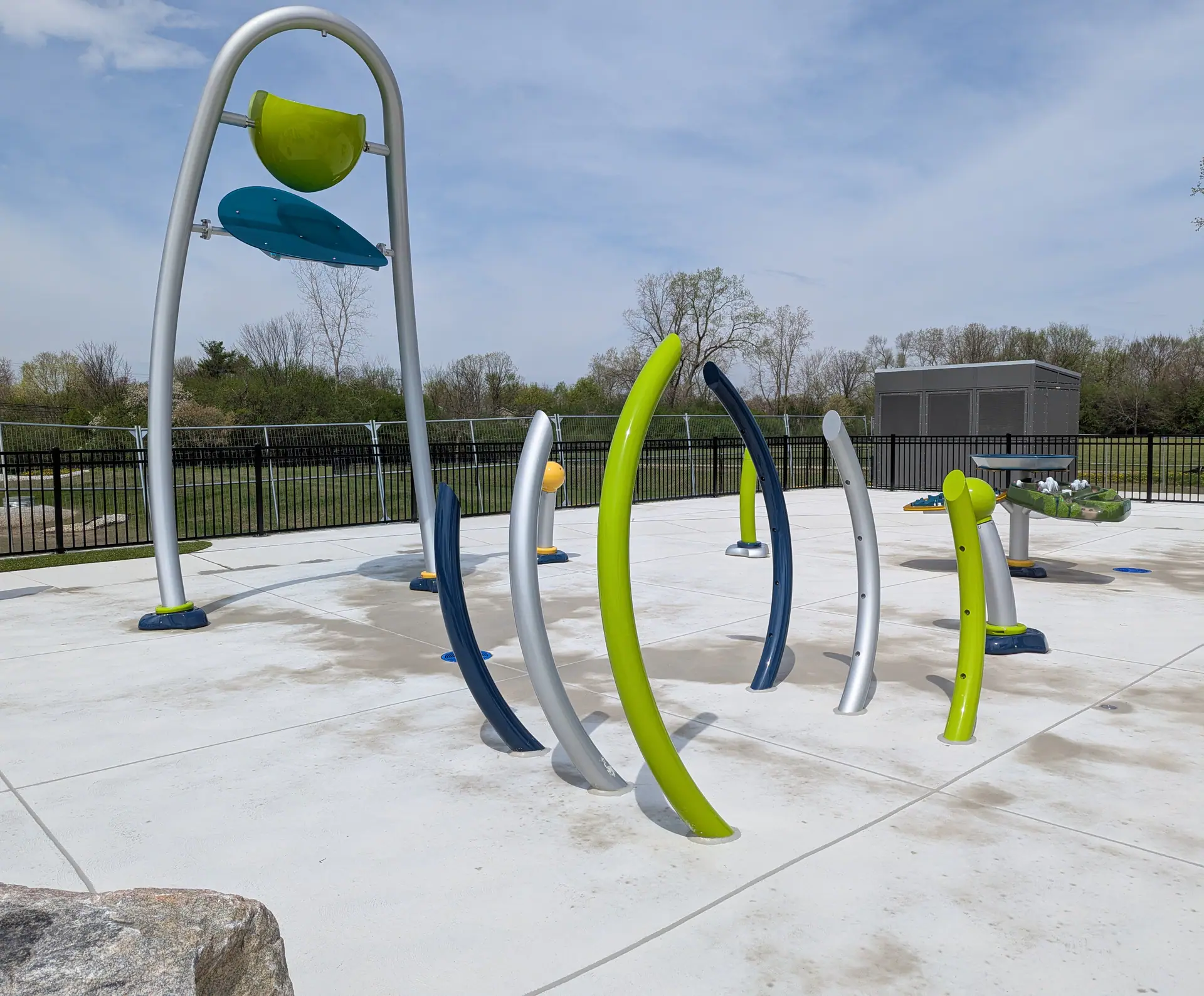Dump bucket, spray hoops, and water-play posts at Bicentennial Park Splash Pad