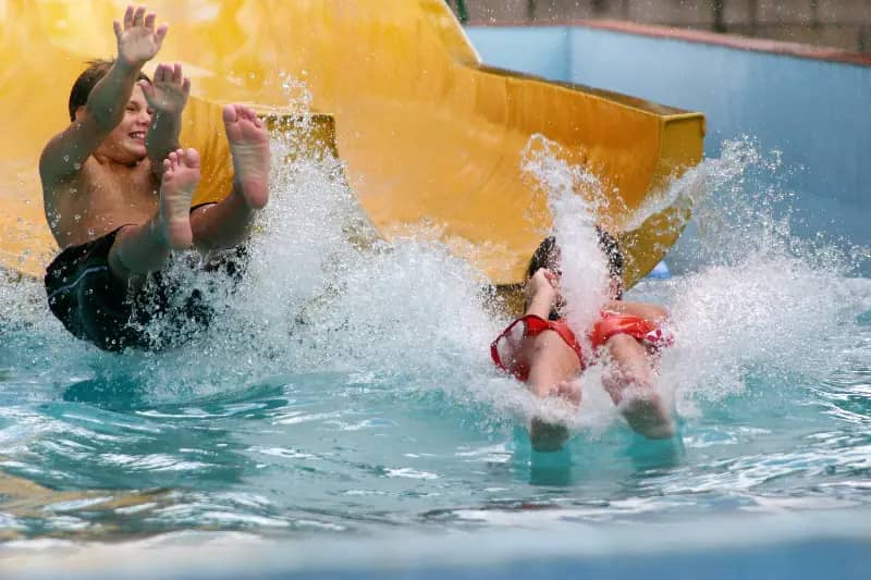 Indoor family pool scene used by The Alaska Club for pool and play party promotions.