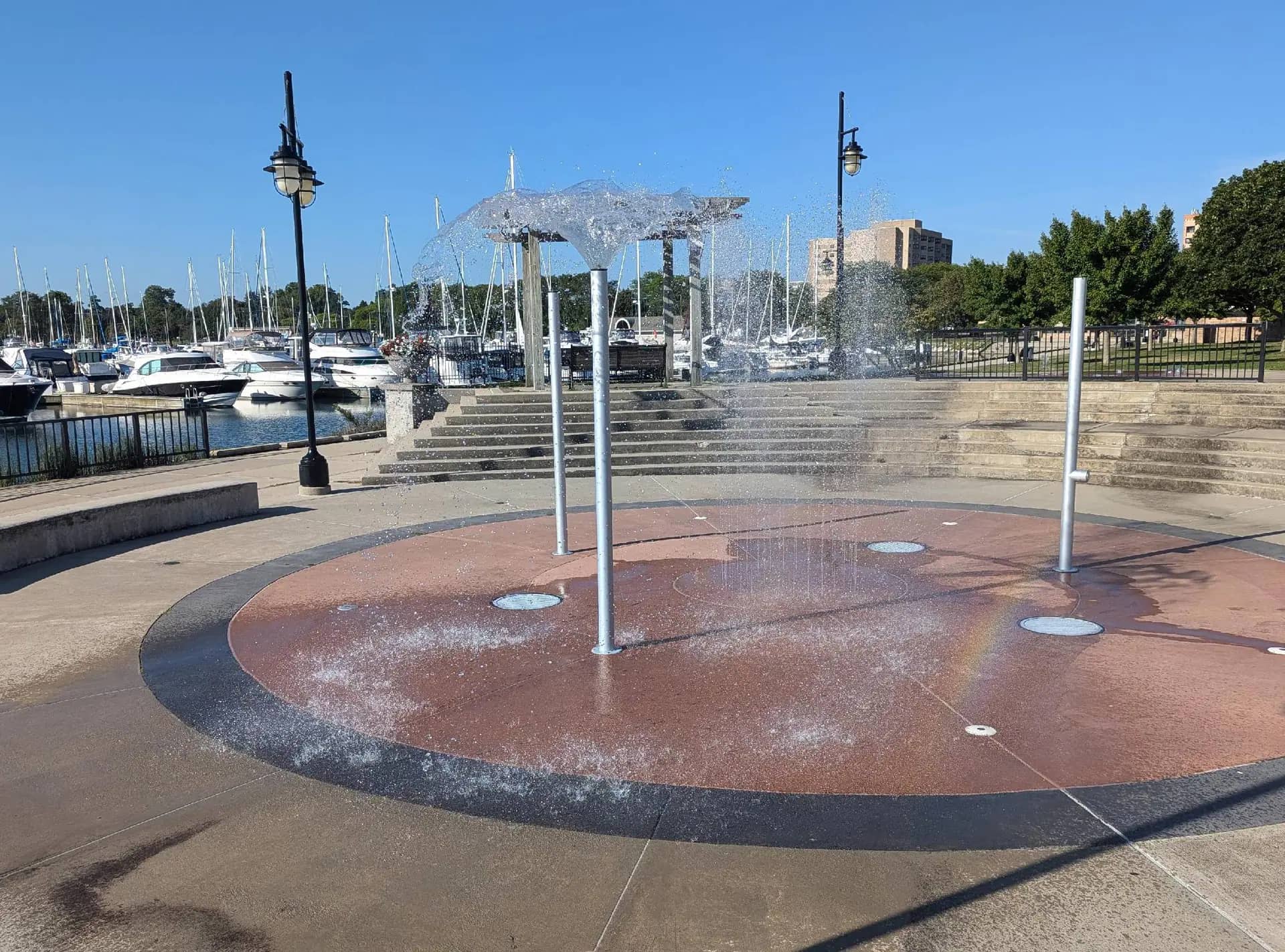 Wide view of a Kenosha splash pad in use during summer.